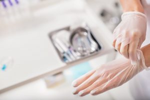 Bay Medical is a medical supply store online that specializes in respiratory and anesthesia supplies. A doctor places latex gloves on before intubating.